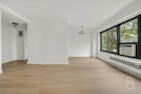 a view of a livingroom with an empty space and a window