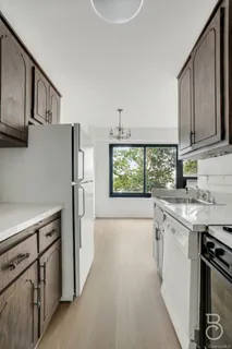 a kitchen with a stove a sink and a refrigerator