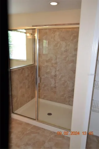 a bathroom with a glass shower door