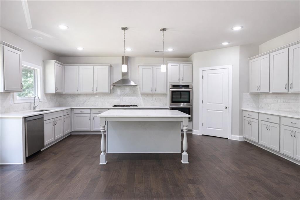 25 Hornbeam Way Covington, GA 30014 - Photo 11 of 31 a kitchen with a refrigerator and white cabinets