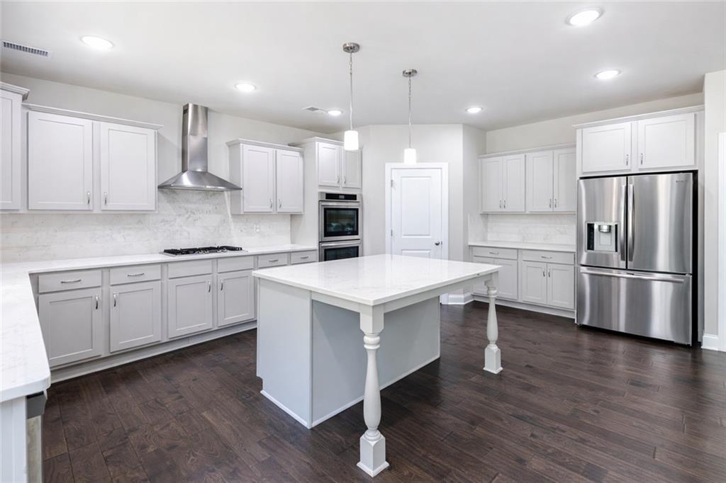 25 Hornbeam Way Covington, GA 30014 - Photo 12 of 31 a kitchen with a stove a refrigerator and a sink