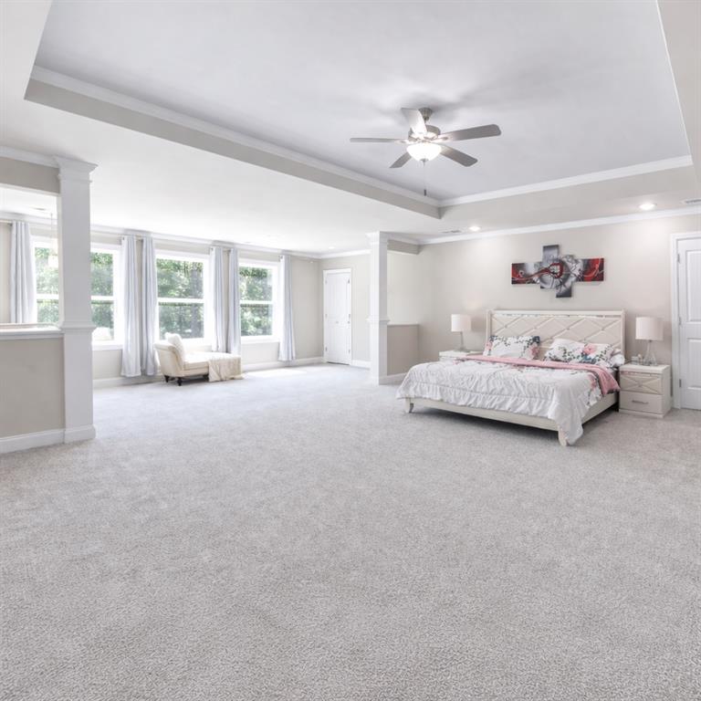25 Hornbeam Way Covington, GA 30014 - Photo 16 of 31 a spacious bedroom with a bed couch and a large window