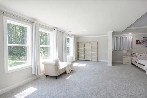 a spacious bedroom with a bed and a large window