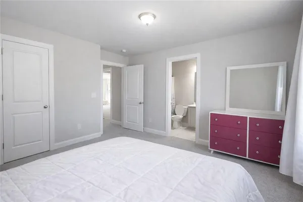 a bedroom with a bed and a dresser