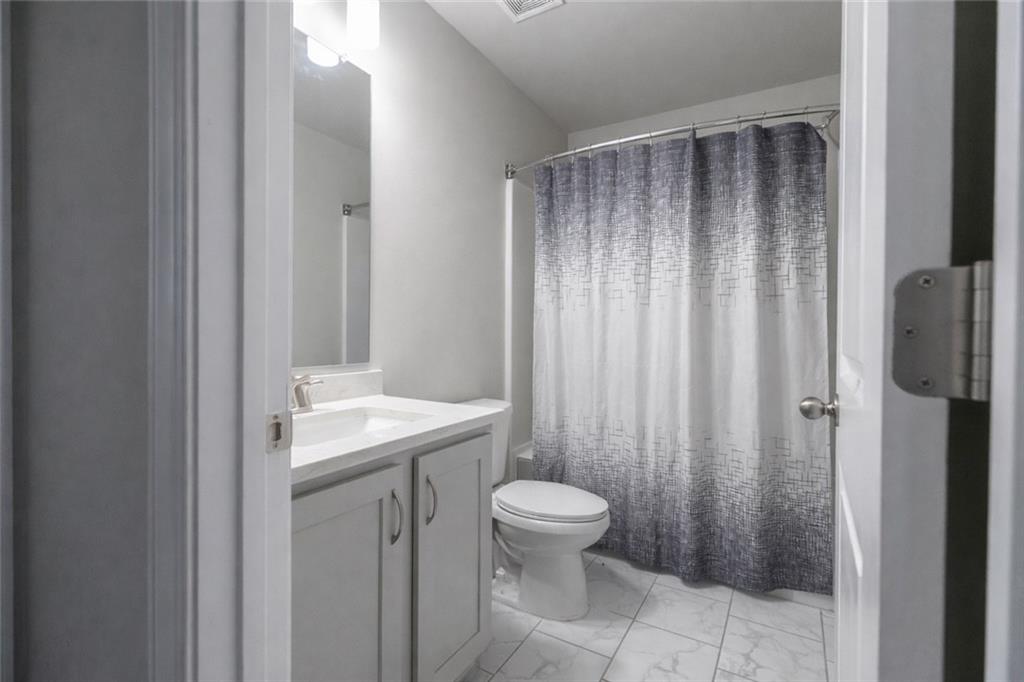 25 Hornbeam Way Covington, GA 30014 - Photo 21 of 31 a bathroom with a sink a toilet and shower