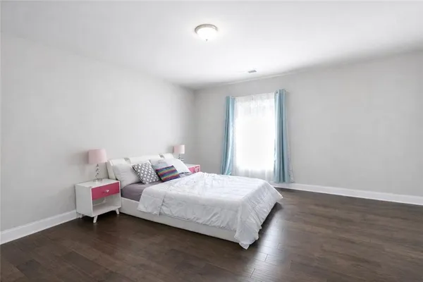 a bedroom with a bed and window