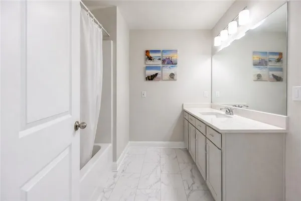 a bathroom with a sink vanity granite and a mirror