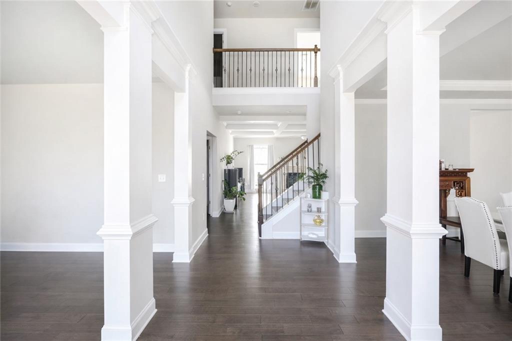 25 Hornbeam Way Covington, GA 30014 - Photo 3 of 31 a hallway with wooden floor table and chairs