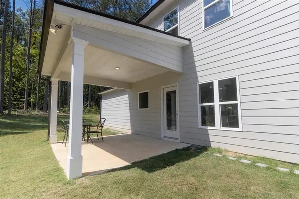 a view of house with backyard