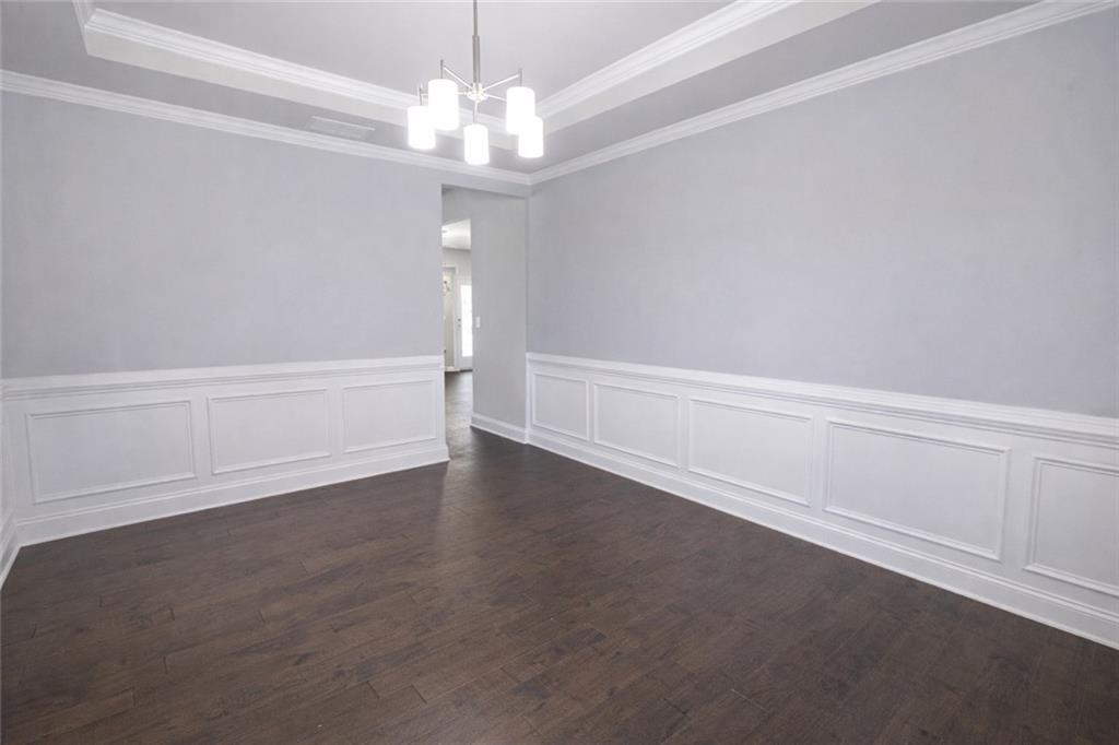 25 Hornbeam Way Covington, GA 30014 - Photo 4 of 31 en empty room with wooden floor and ceiling fan