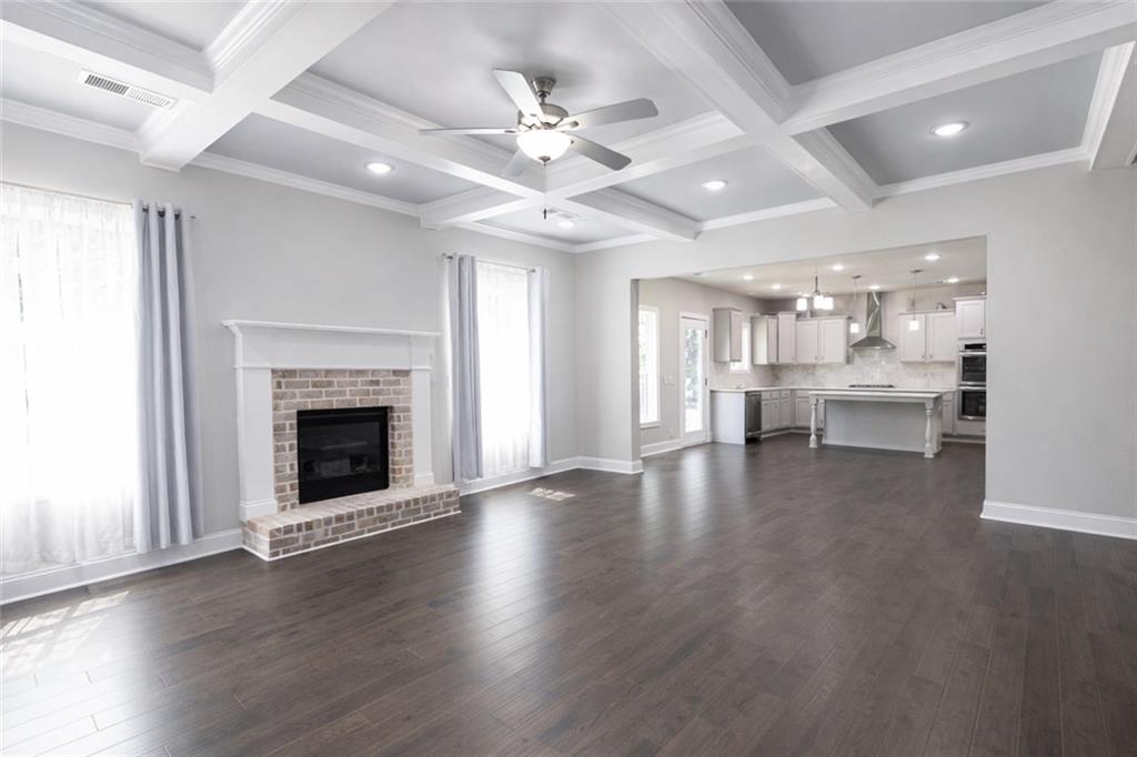 25 Hornbeam Way Covington, GA 30014 - Photo 6 of 31 an empty room with wooden floor fireplace and windows