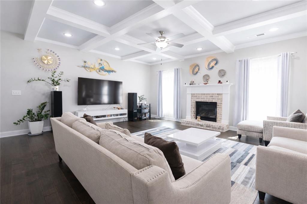 25 Hornbeam Way Covington, GA 30014 - Photo 8 of 31 a living room with furniture a flat screen tv and a fireplace