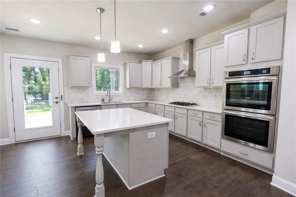 25 Hornbeam Way Covington, GA 30014 - Photo 10 of 31 a kitchen with stainless steel appliances granite countertop a stove a sink and a microwave