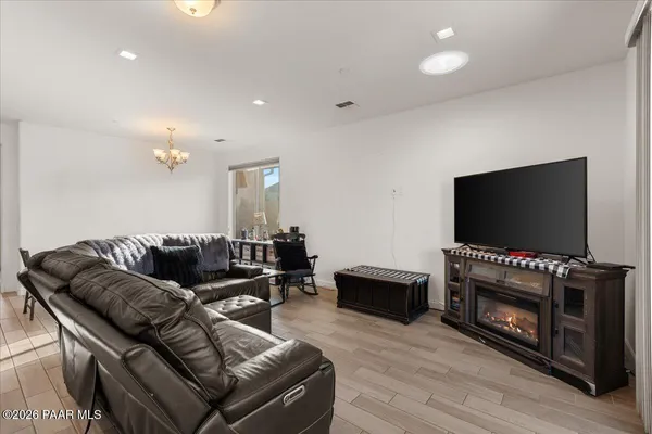 a living room with furniture and kitchen view