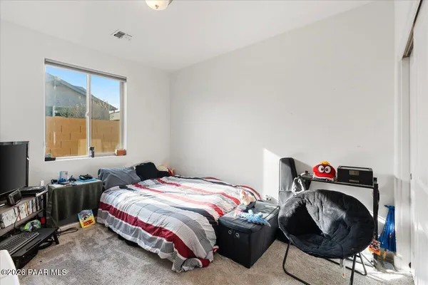 a bedroom with furniture and a window