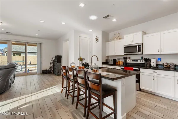 a kitchen with stainless steel appliances a refrigerator stove microwave and cabinets