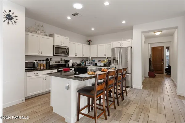 a kitchen with sink refrigerator and table