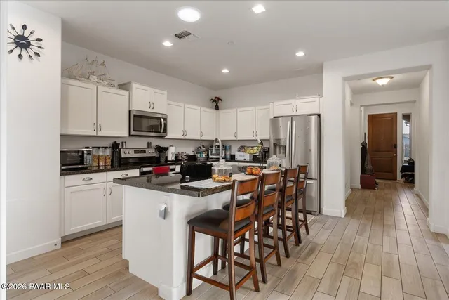 a kitchen with sink refrigerator and table