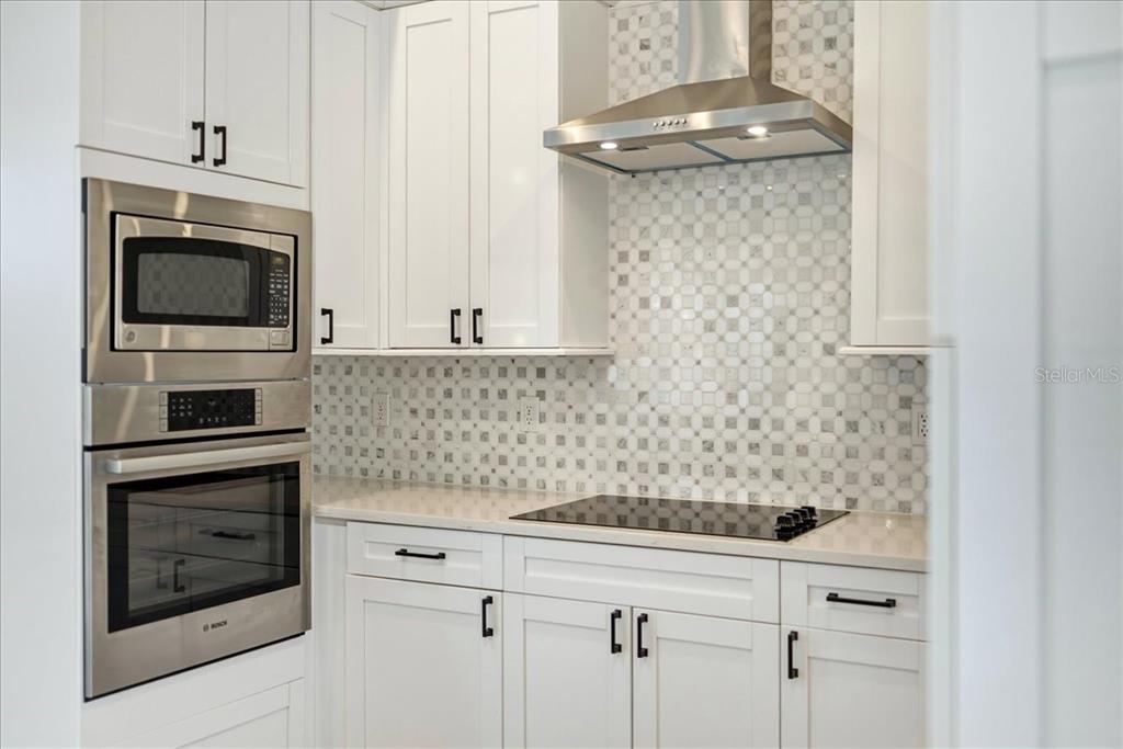 1215 Rio De Janeiro Avenue Punta Gorda, FL 33983 - Photo 31 of 65 a kitchen with a stove and a microwave