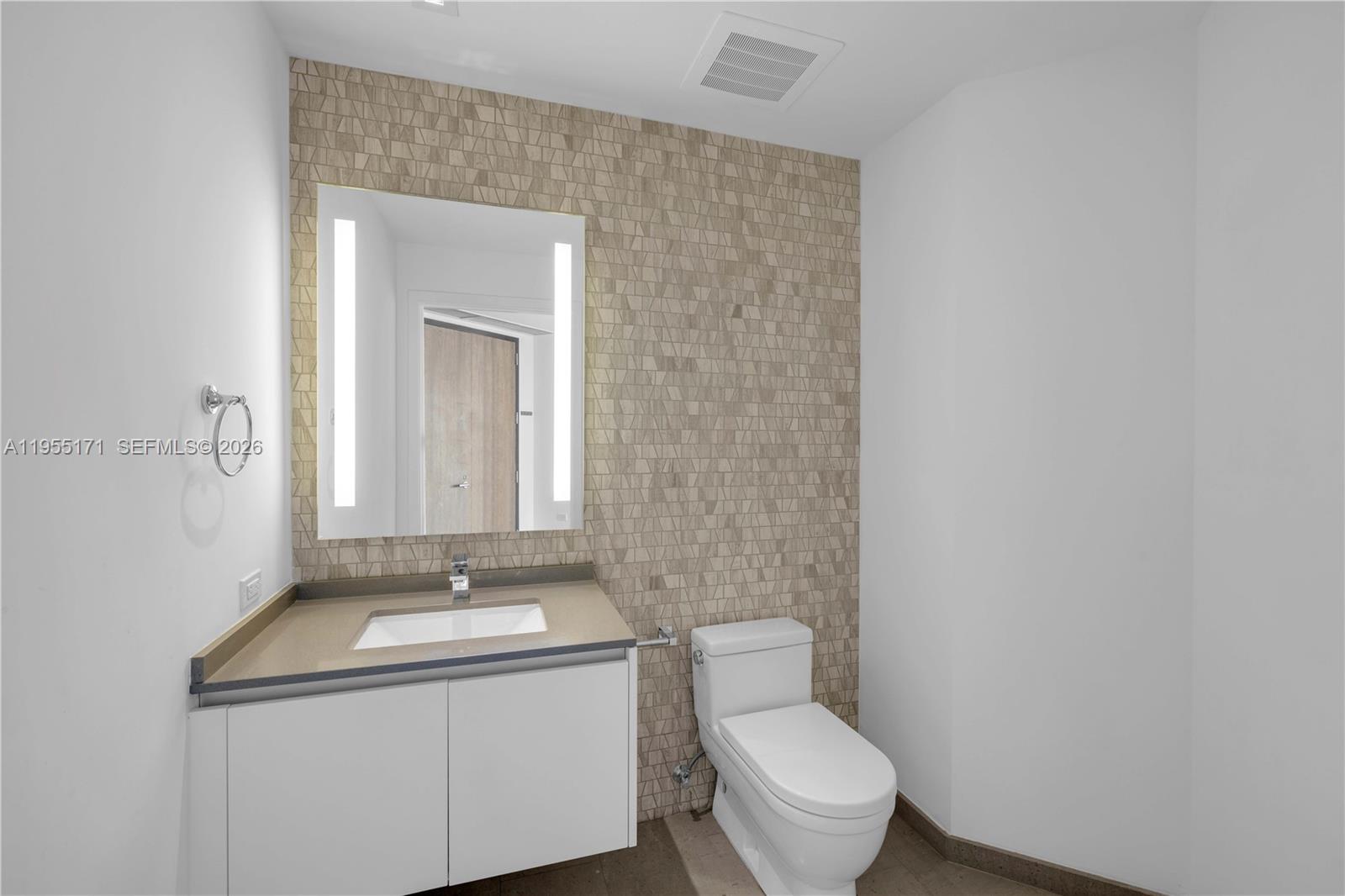 88 Southwest 7th Street, Unit 3711 Miami, FL 33130 - Photo 18 of 47 a bathroom with a toilet sink and mirror