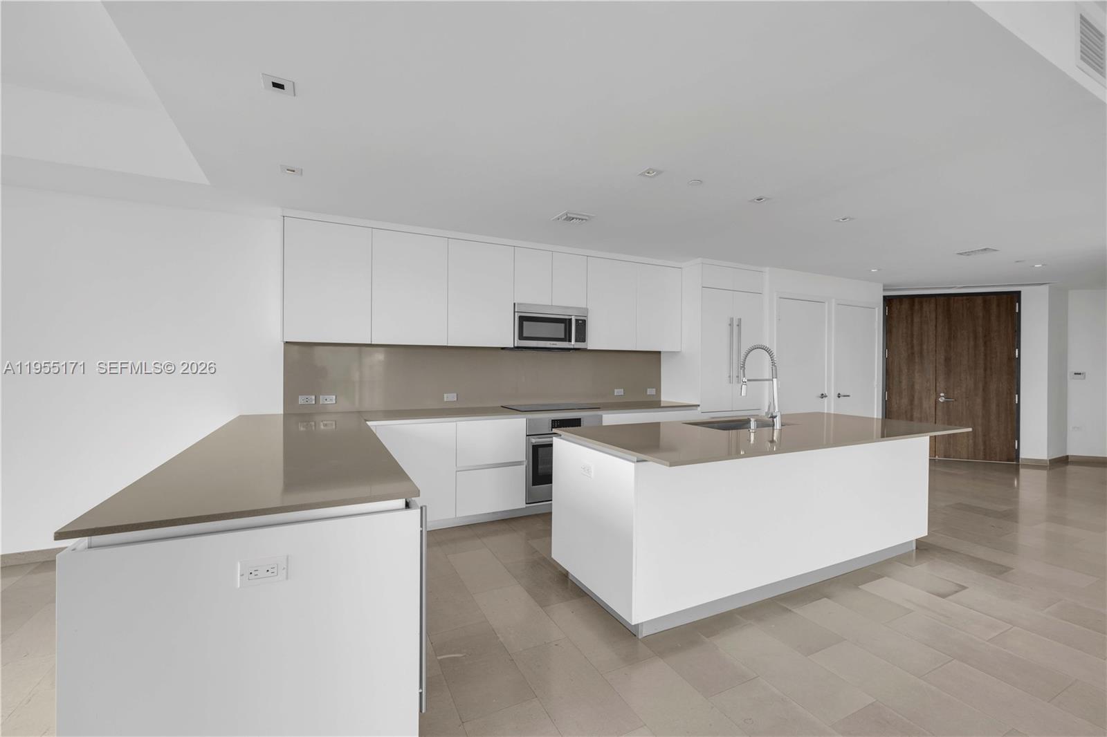 88 Southwest 7th Street, Unit 3711 Miami, FL 33130 - Photo 2 of 47 a living room with stainless steel appliances white cabinets and a couch