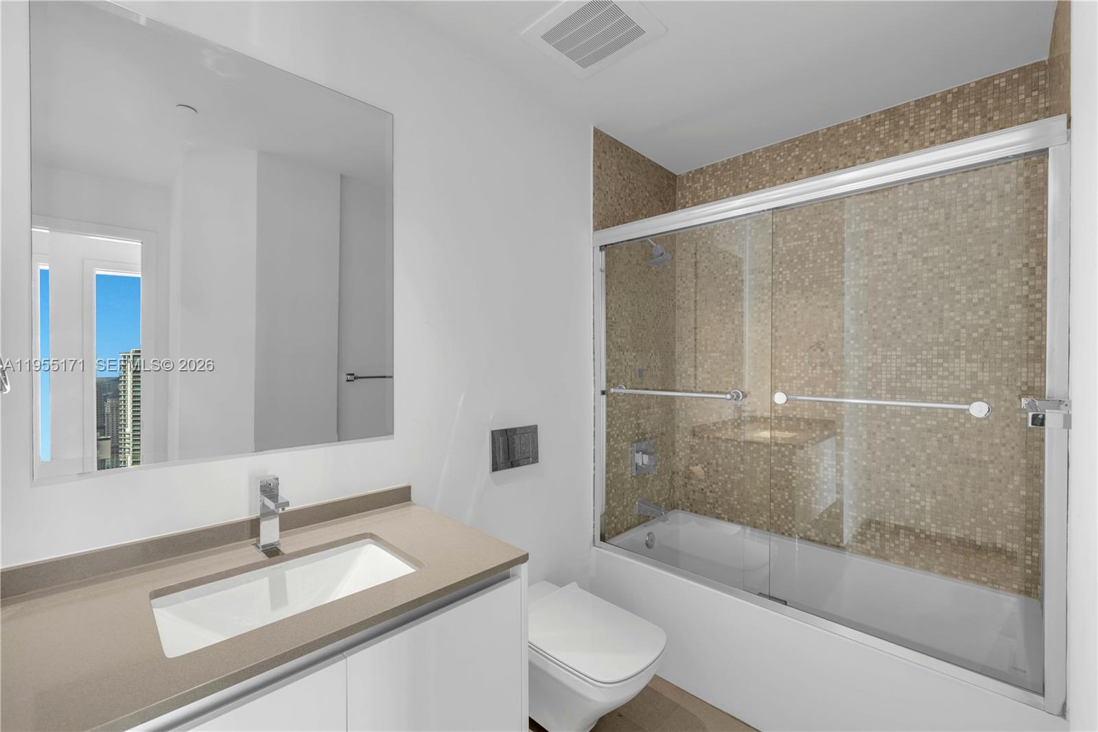88 Southwest 7th Street, Unit 3711 Miami, FL 33130 - Photo 23 of 47 a bathroom with a sink a toilet and bathtub