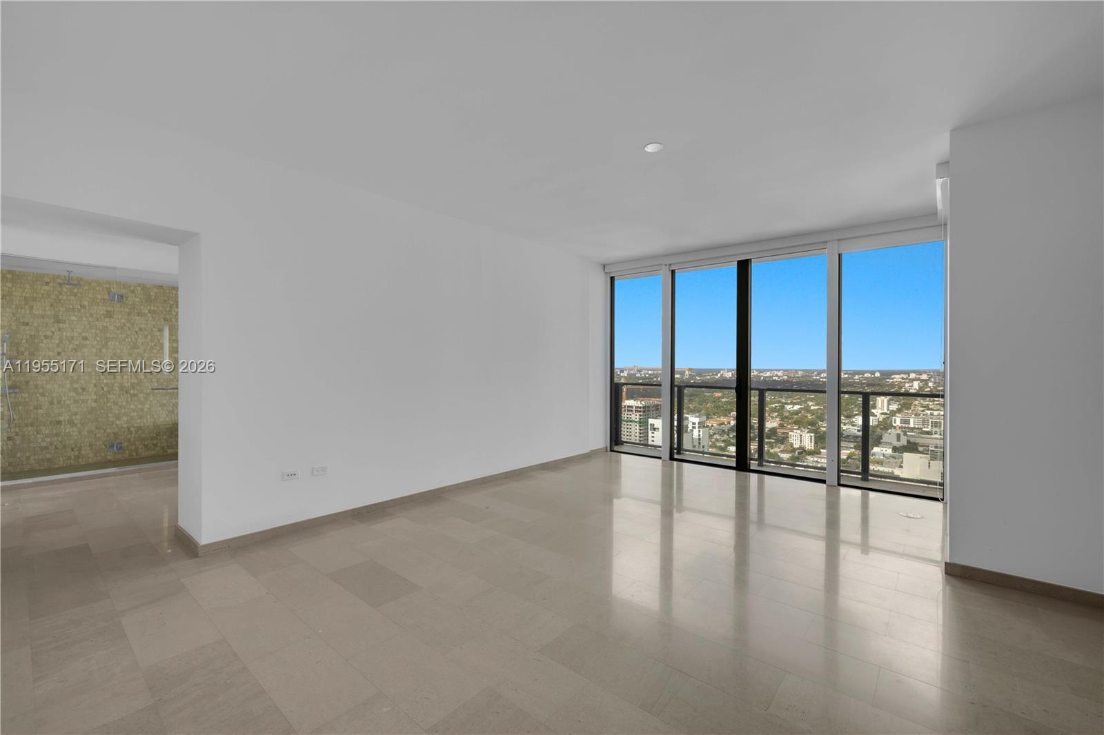 88 Southwest 7th Street, Unit 3711 Miami, FL 33130 - Photo 31 of 47 an empty room with wooden floor and glass door