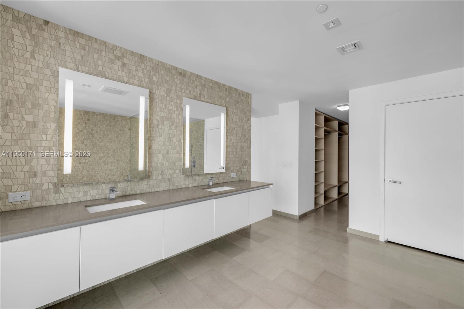 88 Southwest 7th Street, Unit 3711 Miami, FL 33130 - Photo 36 of 47 a large bathroom with a double vanity sink and a mirror