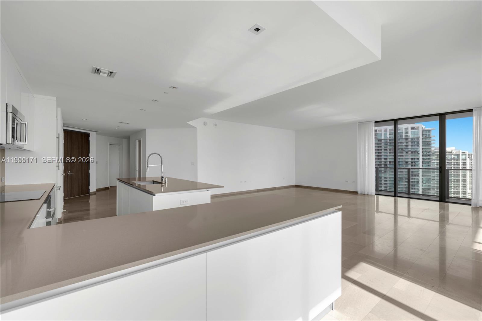 88 Southwest 7th Street, Unit 3711 Miami, FL 33130 - Photo 4 of 47 a view of a kitchen counter top space and wooden floor
