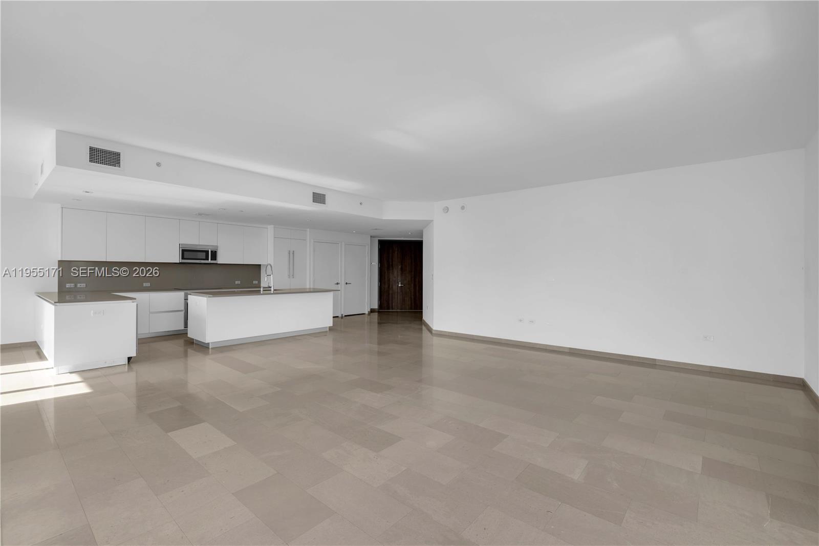 88 Southwest 7th Street, Unit 3711 Miami, FL 33130 - Photo 6 of 47 a view of a kitchen with a sink and a refrigerator