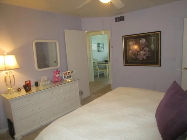 a bedroom with a bed and a mirror