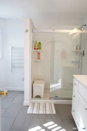 a spacious bathroom with a double vanity sink and a mirror