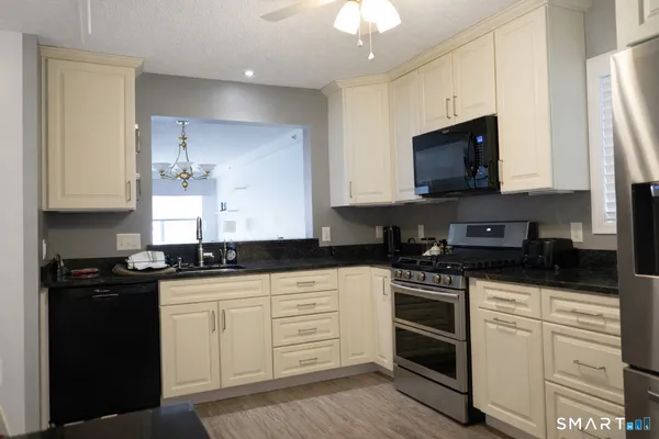 a view of a livingroom with furniture and a window