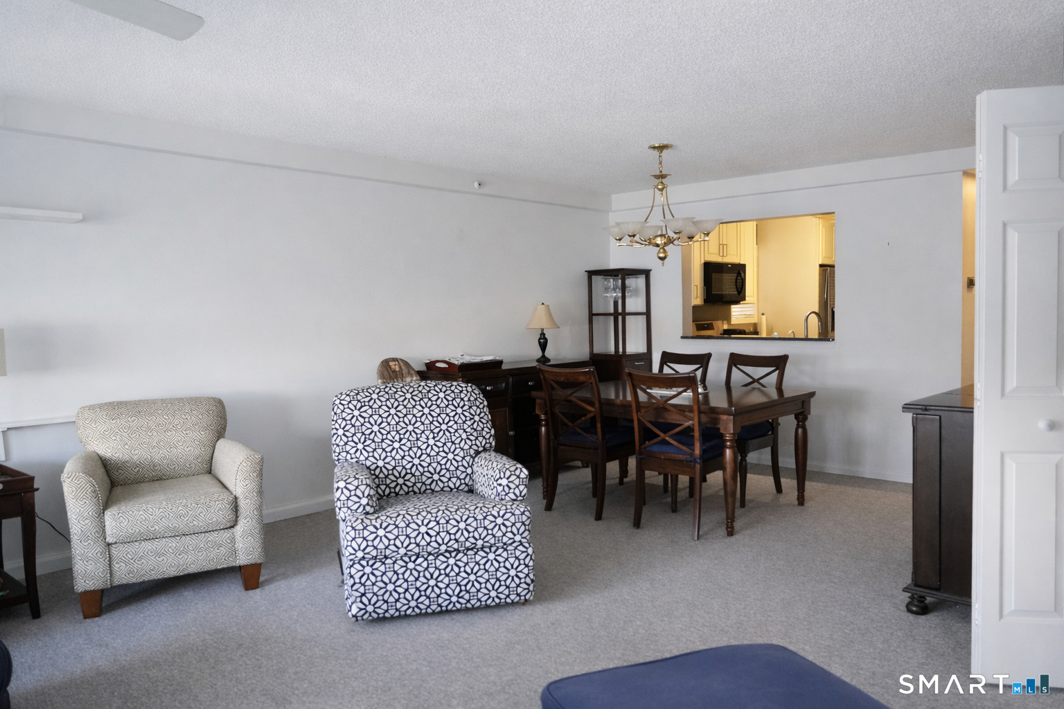 2 Mansfield Grove Road, Unit 170 East Haven, CT 06512 - Photo 8 of 27 a living room with furniture potted plant and a chandelier
