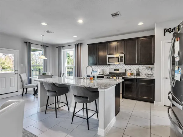 a kitchen with a sink stainless steel appliances and cabinets