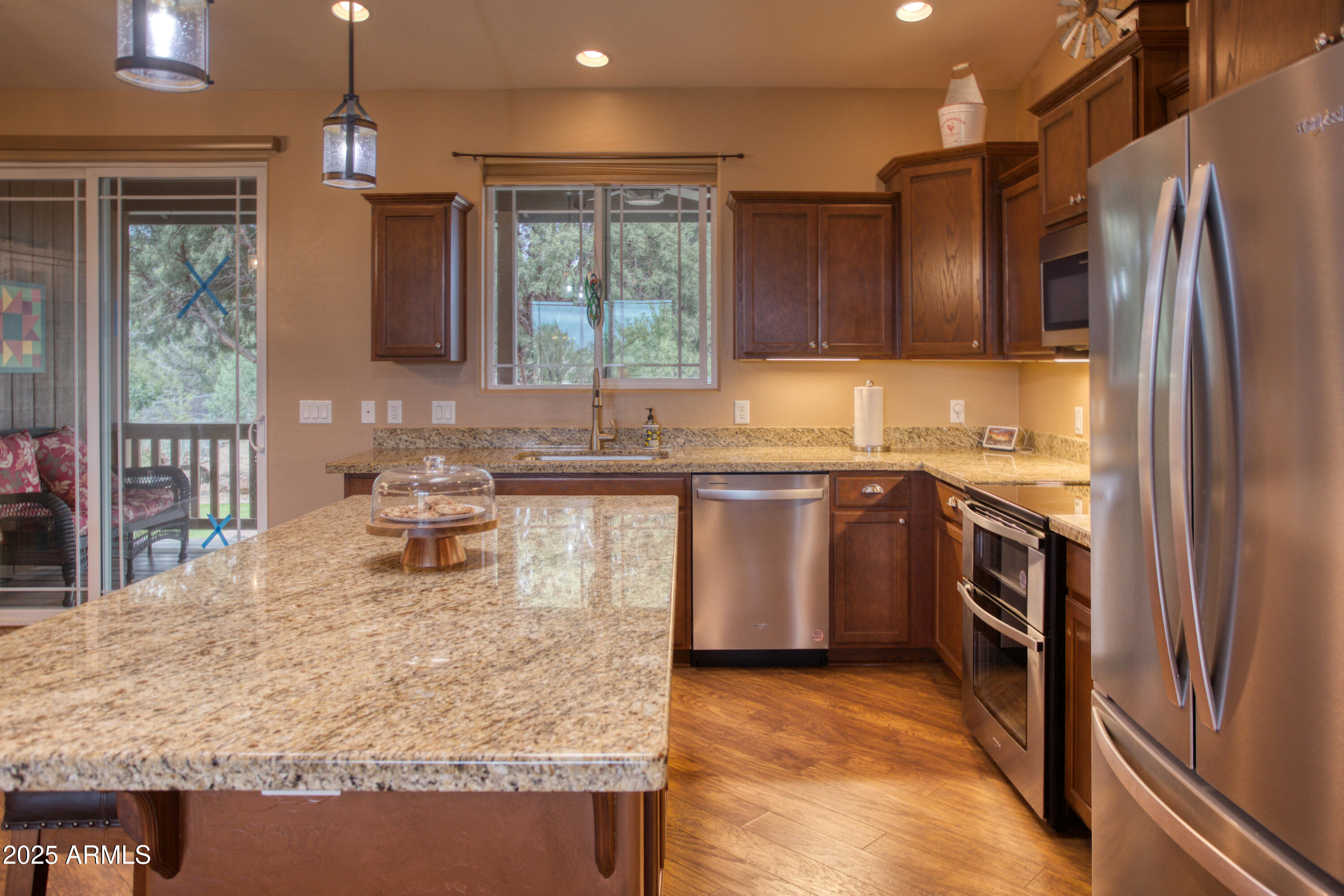 901 South Ridgeline Drive Show Low, AZ 85901 - Photo 5 of 31 a kitchen with stainless steel appliances granite countertop a sink stove and refrigerator