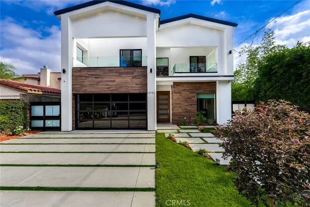 a front view of a house with a garden