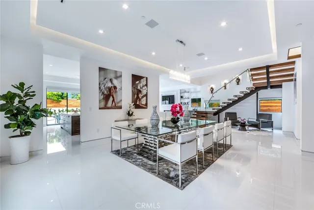 a living room with furniture and potted plants
