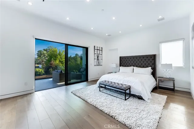 a spacious bedroom with a large bed and a large window