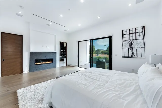a spacious bedroom with a large bed and a fireplace