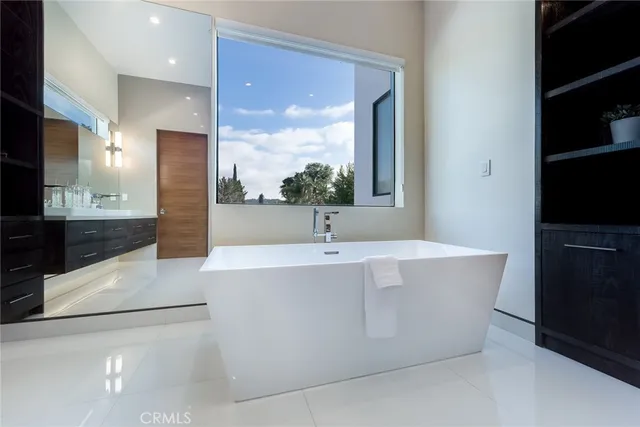 a large white kitchen with a large window
