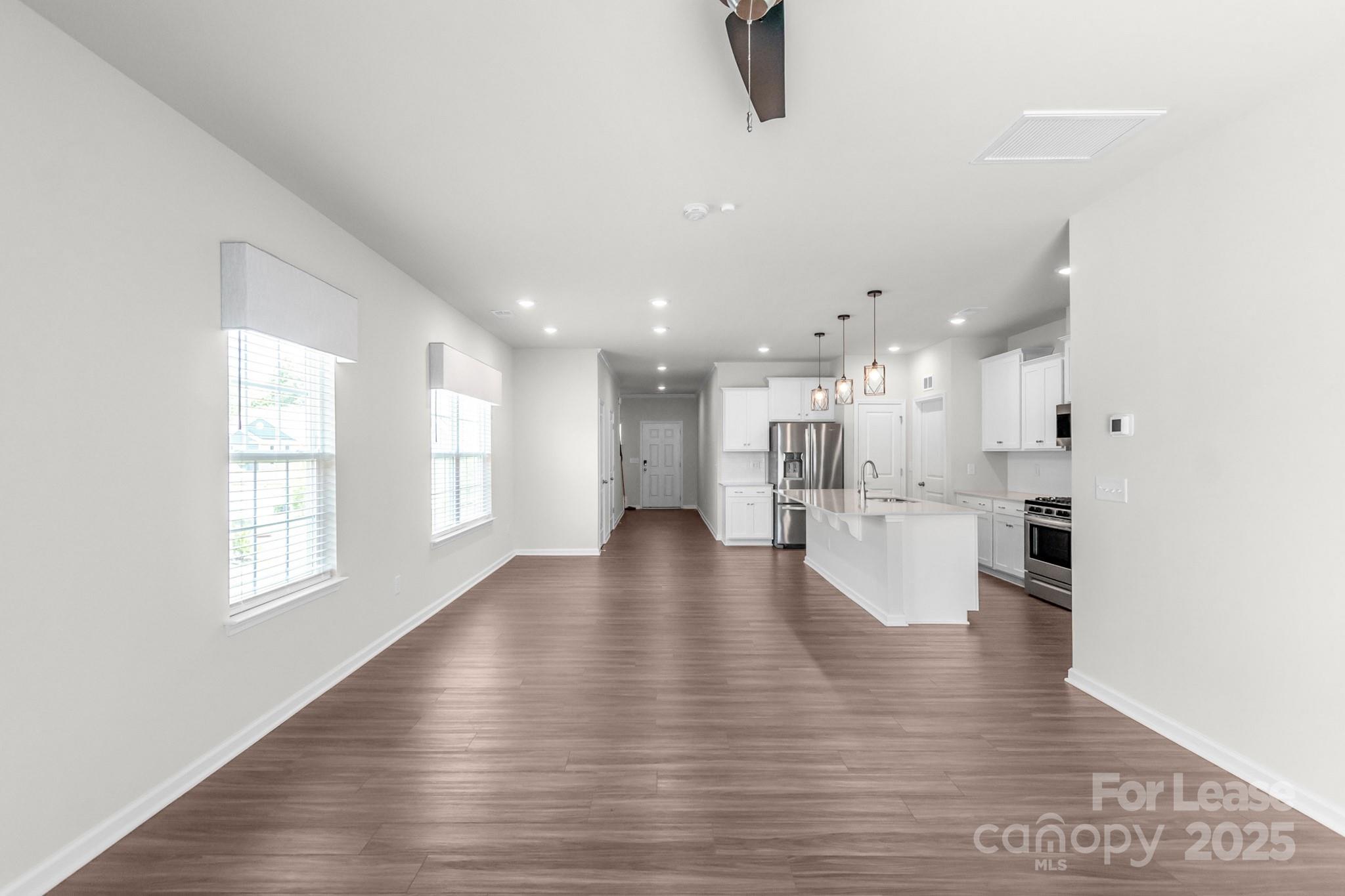 15520 Capps Road Charlotte, NC 28278 - Photo 11 of 48 a view of an empty room and kitchen view with wooden floor