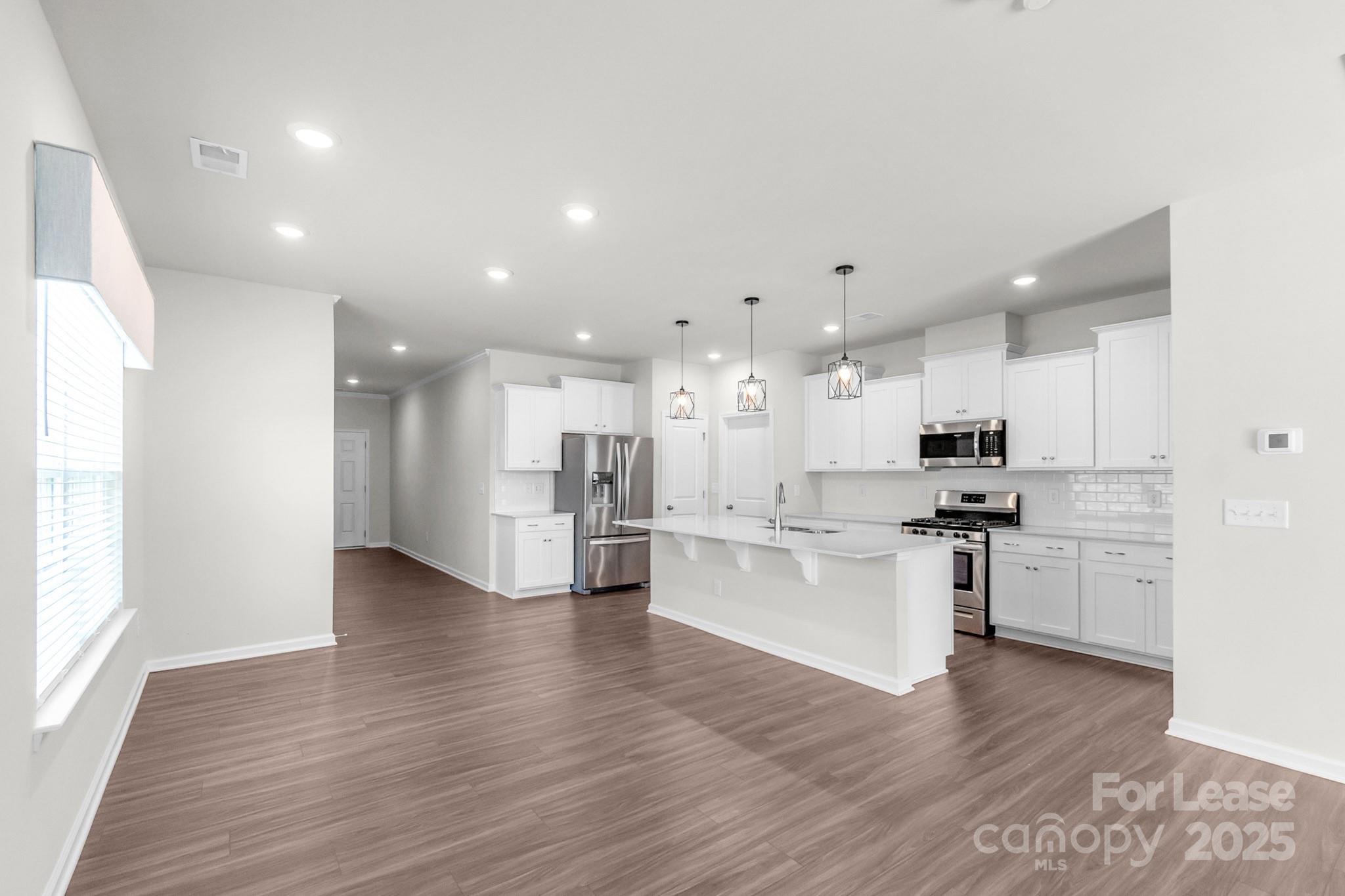 15520 Capps Road Charlotte, NC 28278 - Photo 18 of 48 a kitchen with stainless steel appliances kitchen island sink refrigerator and microwave