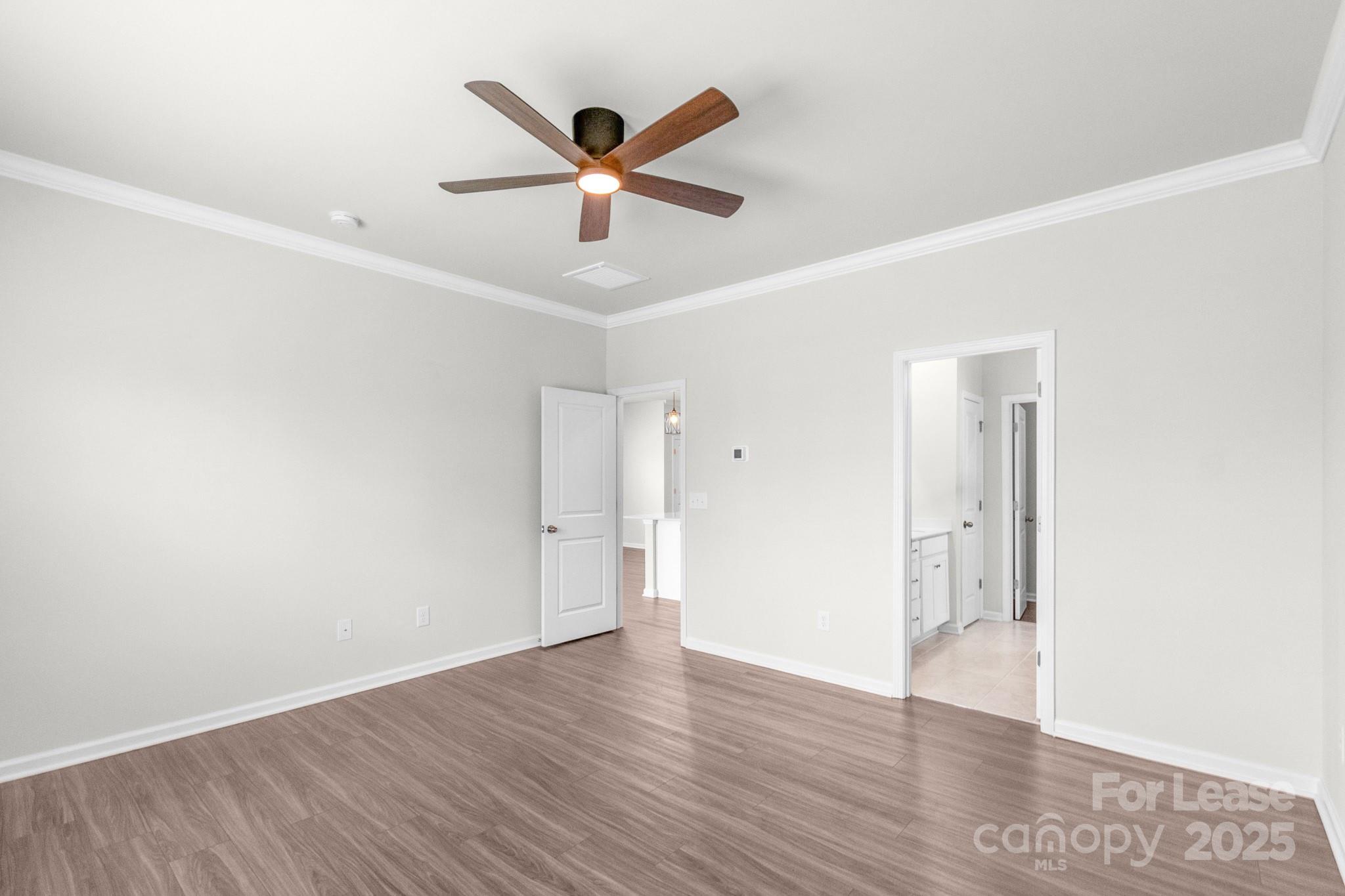 15520 Capps Road Charlotte, NC 28278 - Photo 24 of 48 an empty room with wooden floor and a ceiling fan