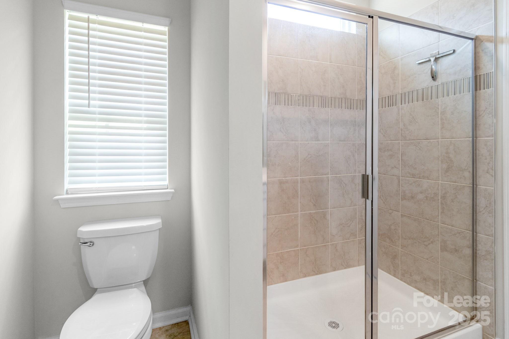 15520 Capps Road Charlotte, NC 28278 - Photo 36 of 48 a bathroom with a toilet and a shower