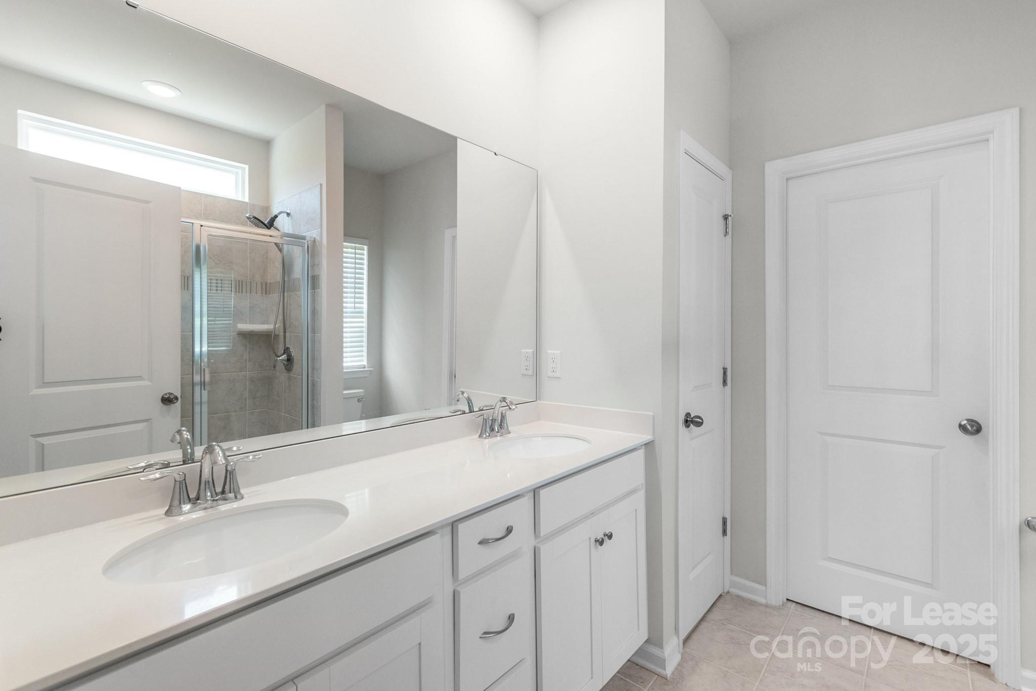 15520 Capps Road Charlotte, NC 28278 - Photo 5 of 48 a bathroom with double sink and a mirror