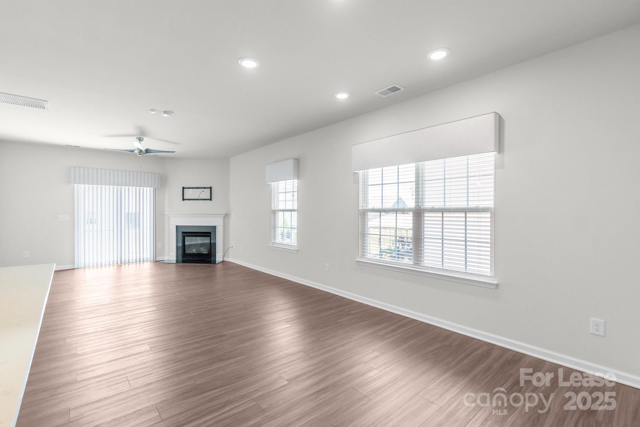 15520 Capps Road Charlotte, NC 28278 - Photo 7 of 48 an empty room with wooden floor and windows