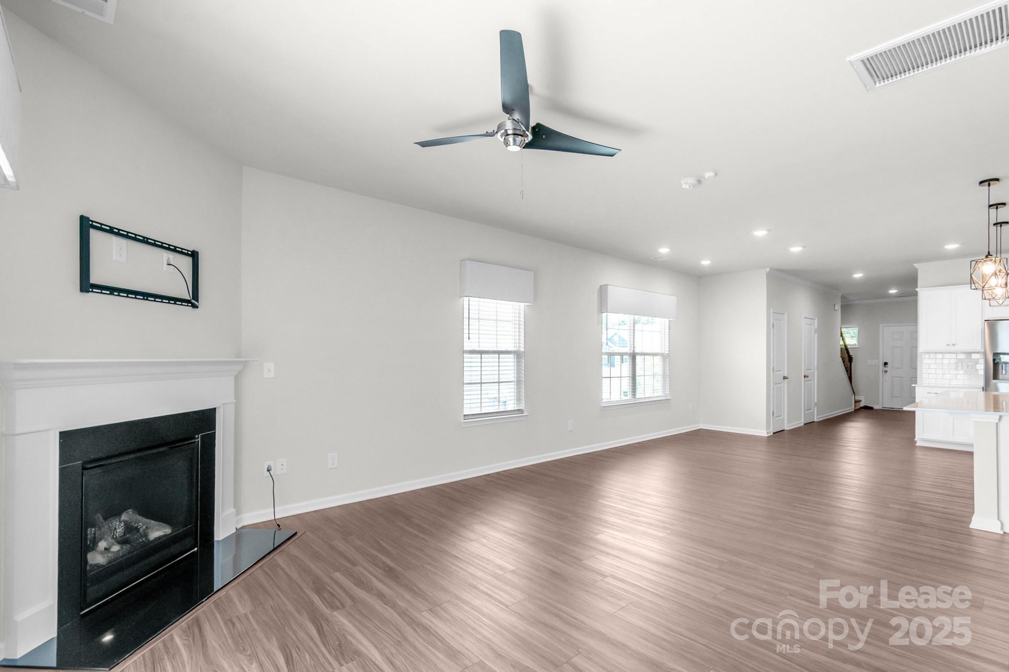 15520 Capps Road Charlotte, NC 28278 - Photo 9 of 48 a view of an empty room with wooden floor fireplace and a window