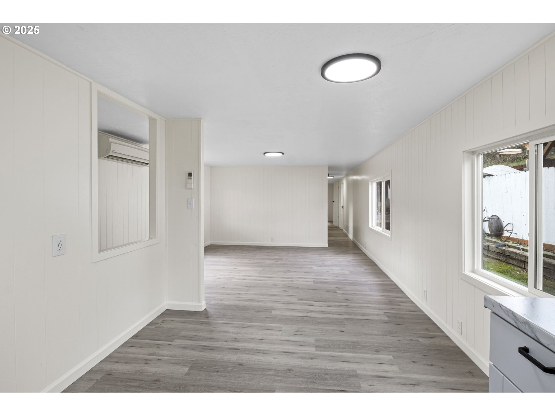 250 Northeast Jorgen Street Winston, OR 97496 - Photo 11 of 36 a view of an empty room with wooden floor and a window