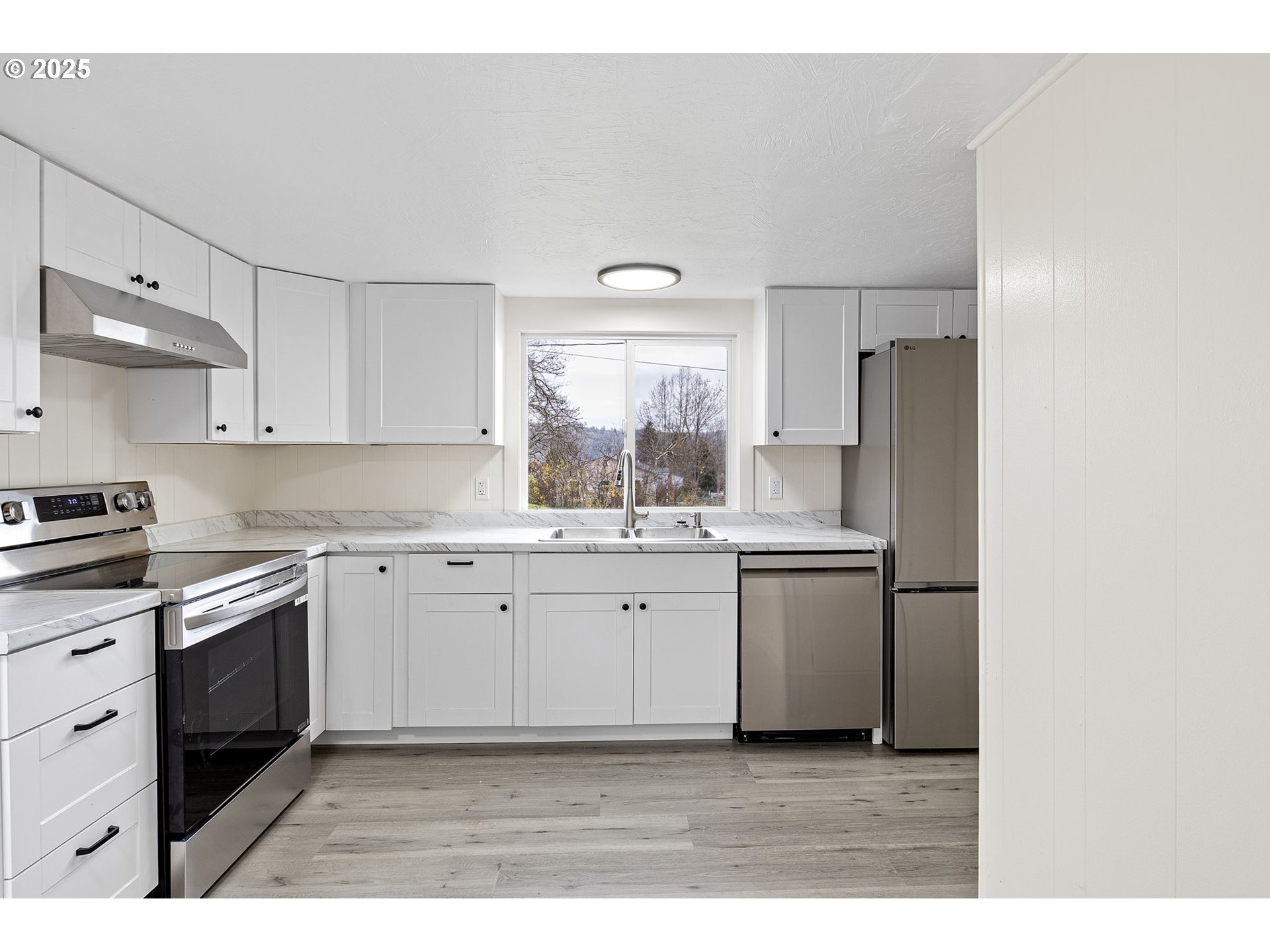 250 Northeast Jorgen Street Winston, OR 97496 - Photo 12 of 36 a kitchen with a white cabinets stove and refrigerator